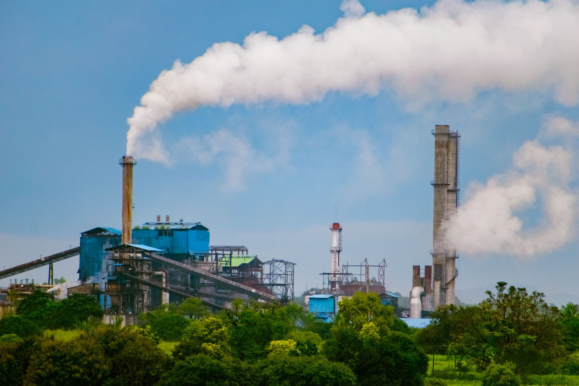 Heavy smog coming out of exhaust pipe of sugar plant.